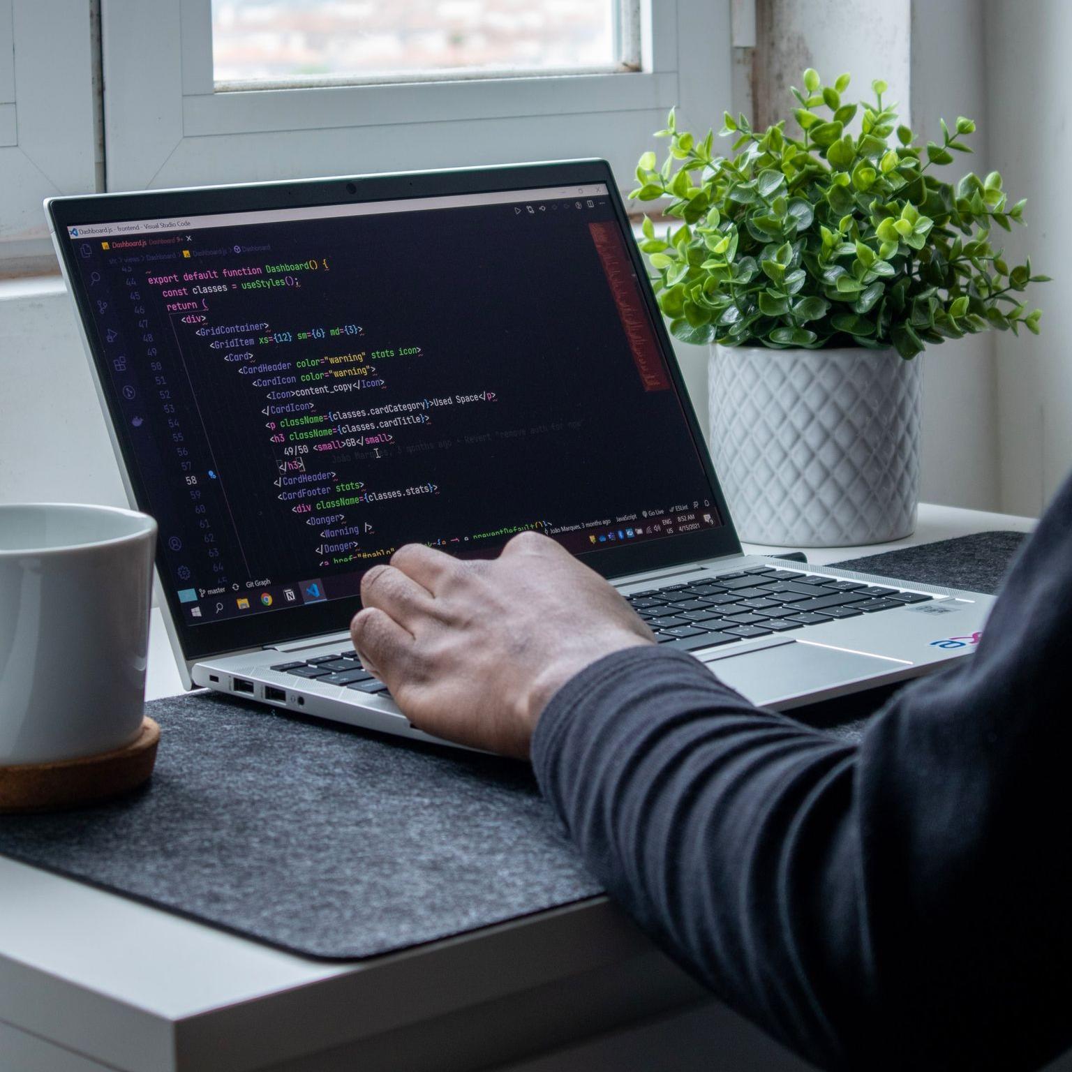 person using macbook pro on table