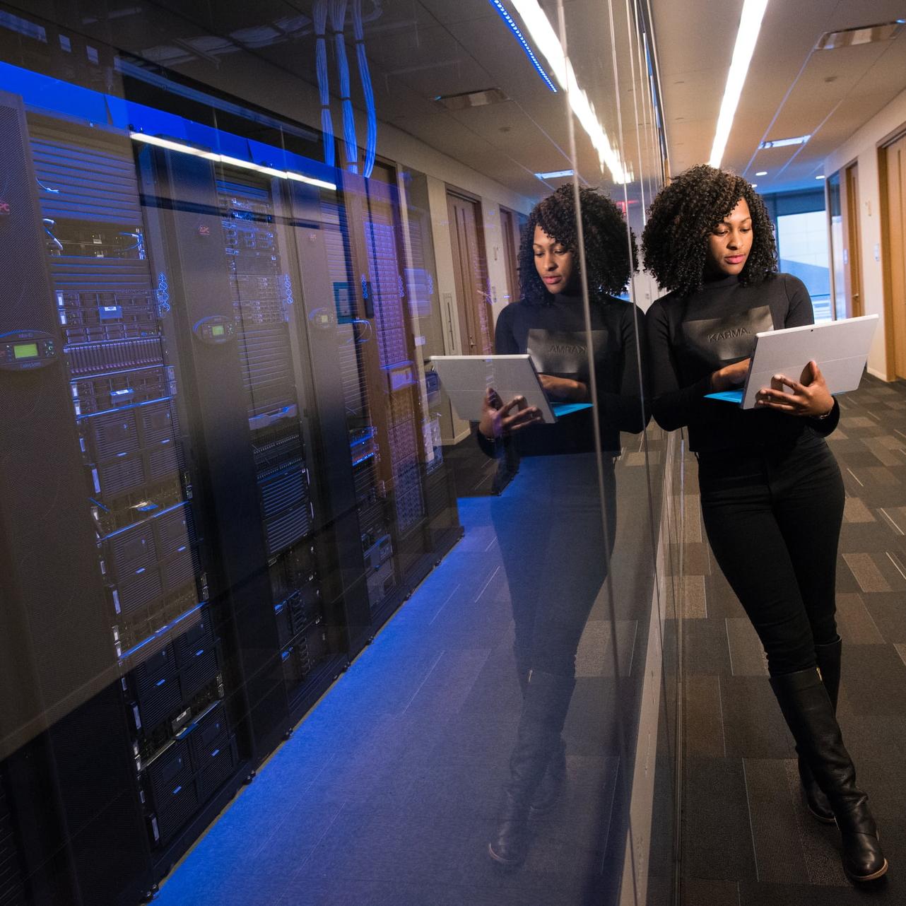 woman in black top using MacBook
